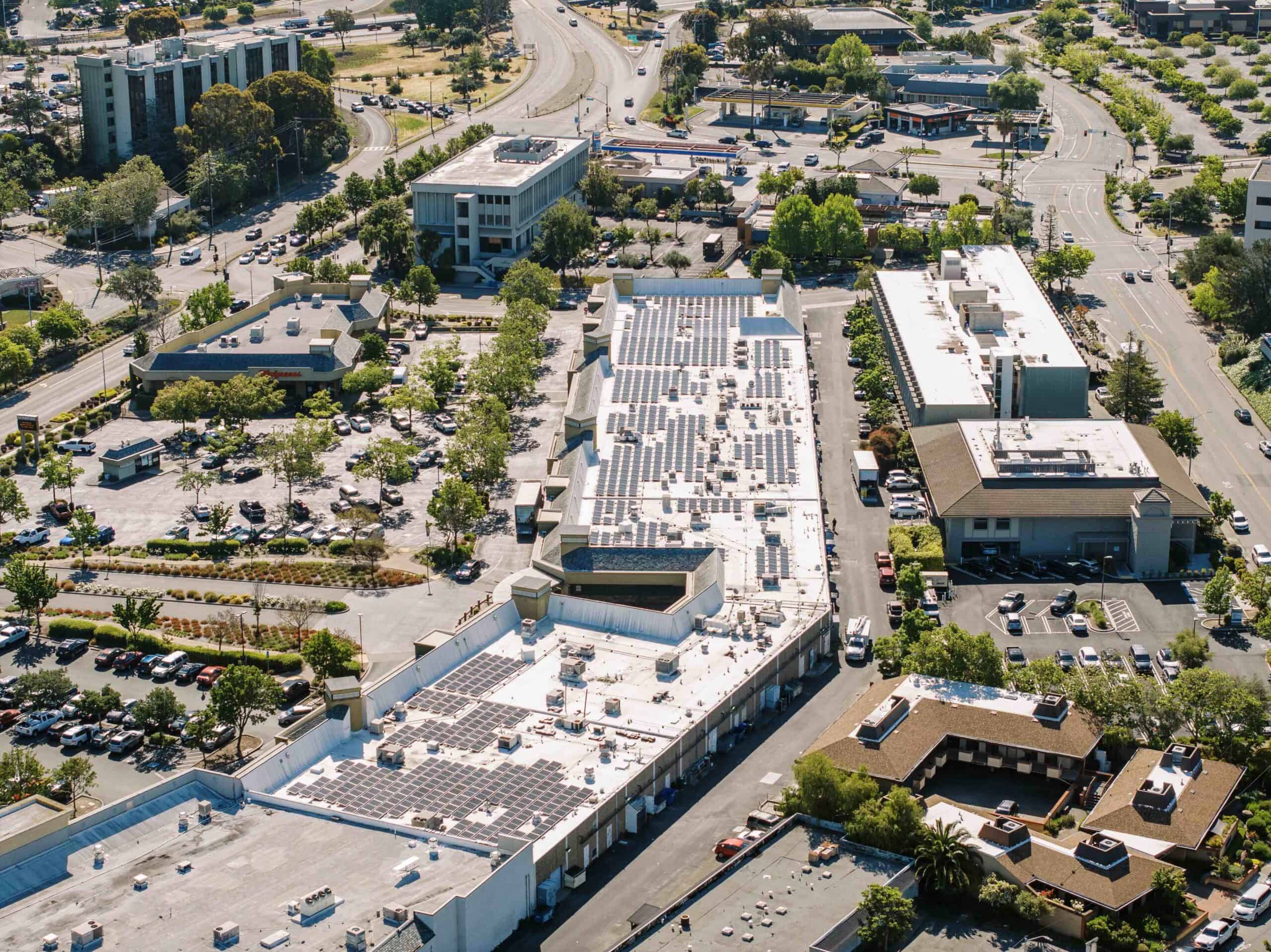 Large solar installation on a flat commercial rooftop on a sunny day.
